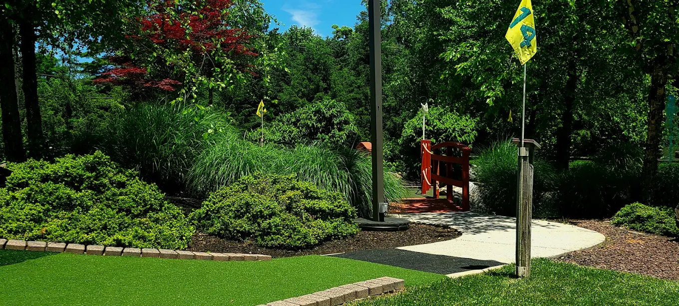 Course hole with red wooden bridge